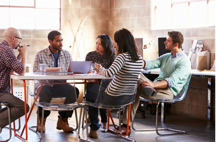 Group of workmates talking to each other Talent management