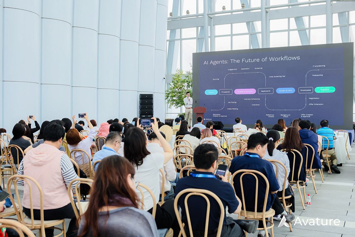 Audience members are engrossed in the presentation of Avature's new AI product.